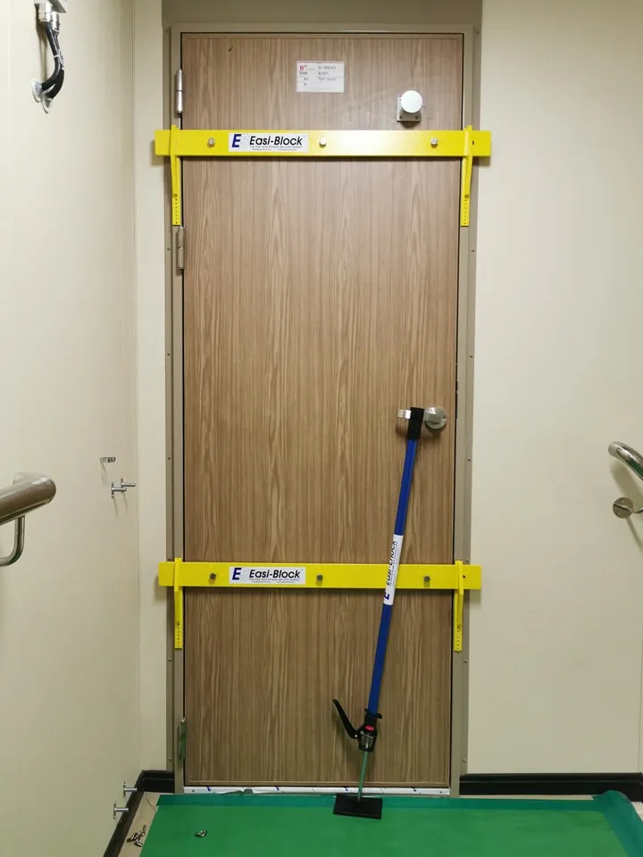 Easi-Block drop down bars installed on a ship cabin door alongside Easi-Chock