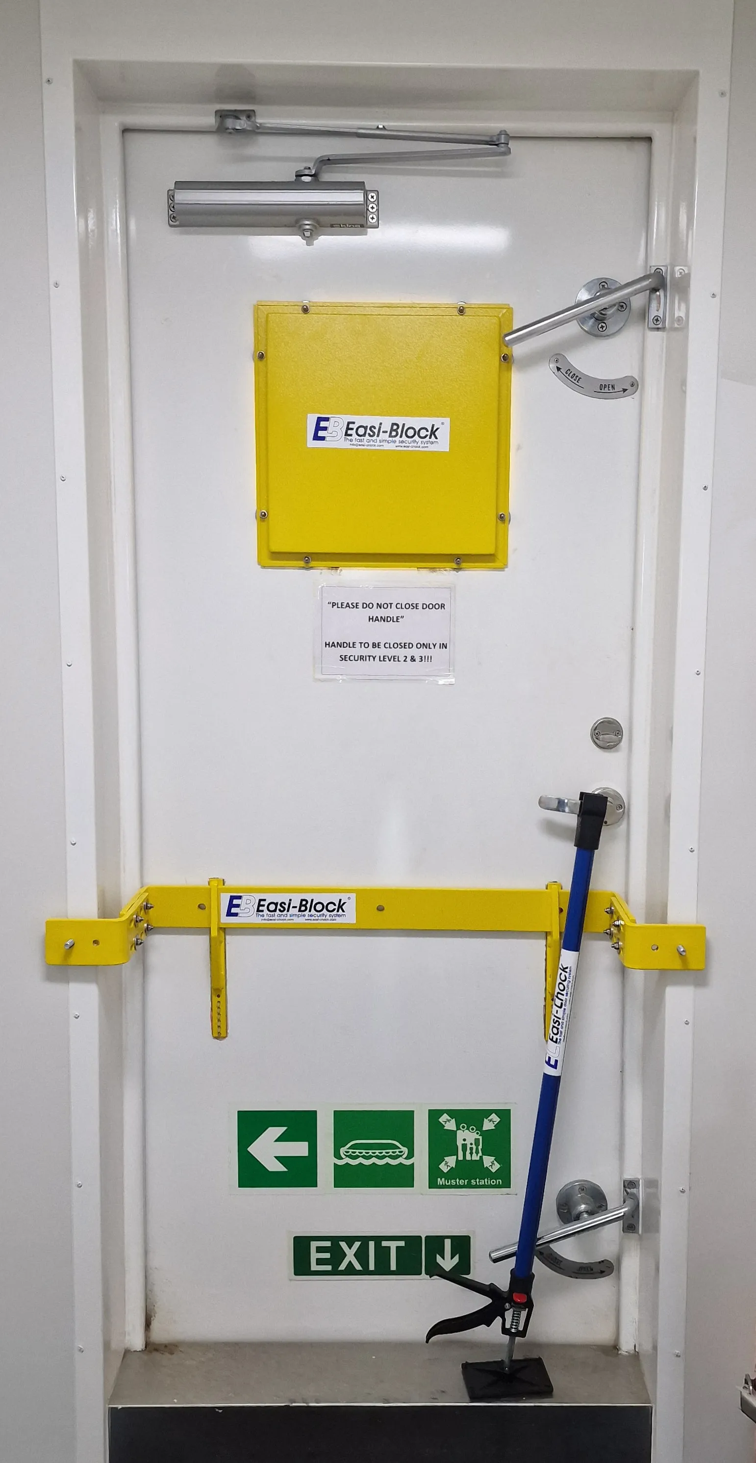 Ship door fitted with Easi-Block vision panel protection, door bars, and Easi-Chock